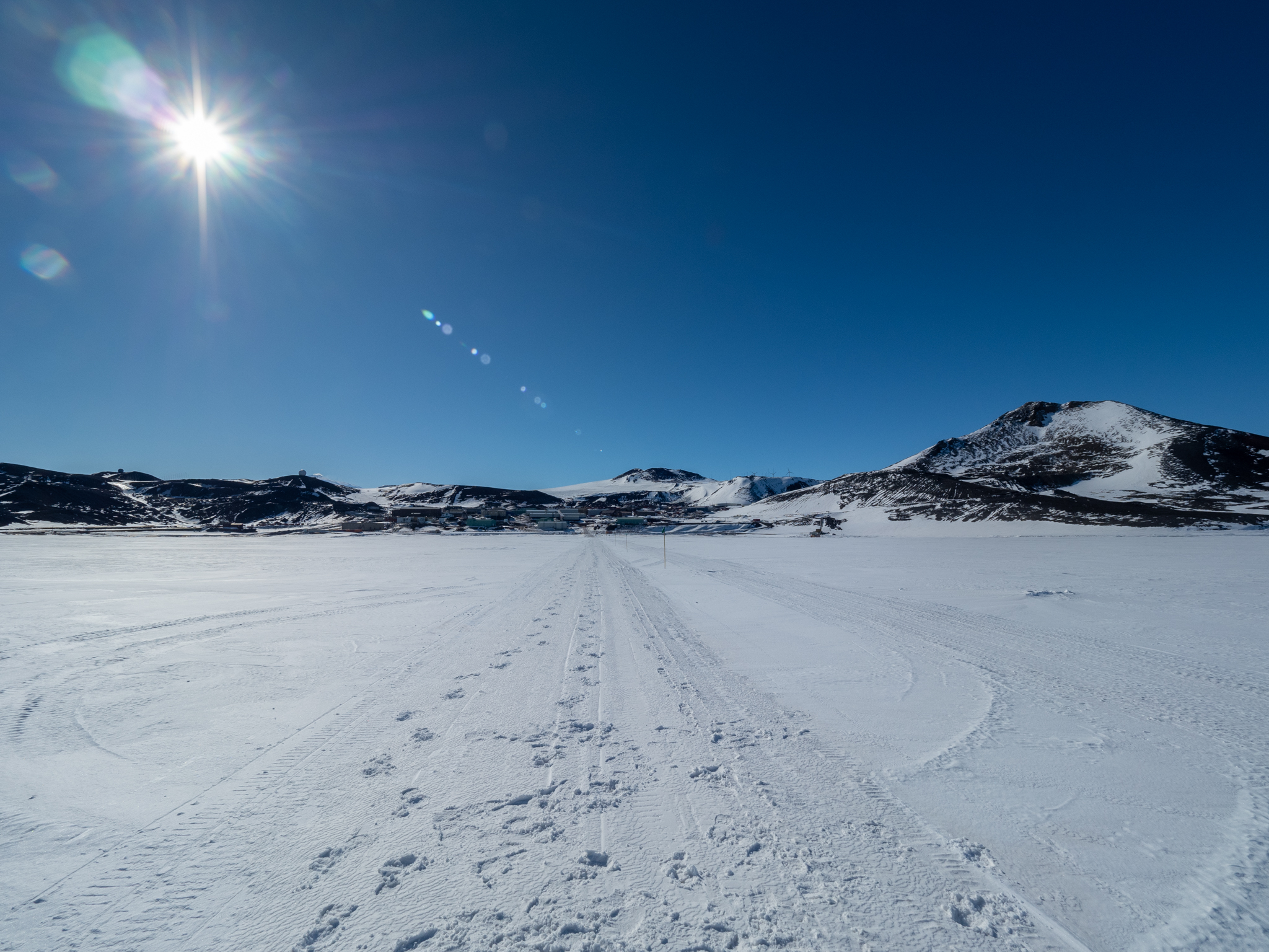 View of mountains in distance, icy trail in foreground.