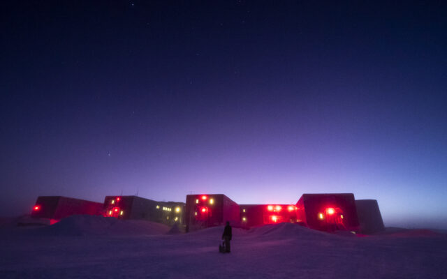 South Pole station with brightening sky at twilight.