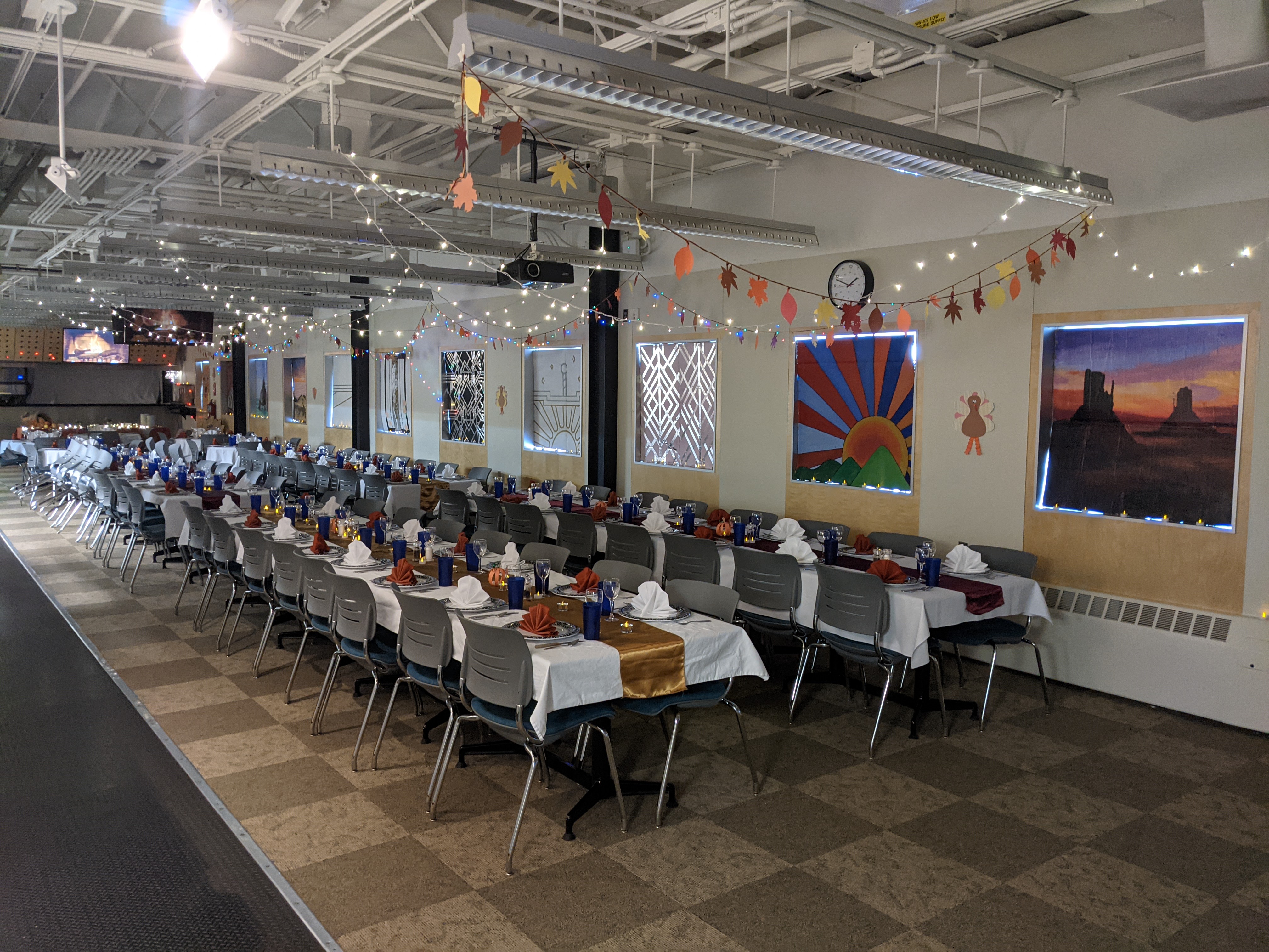 Long tables laid out with formal dinnerware in the South Pole station galley.