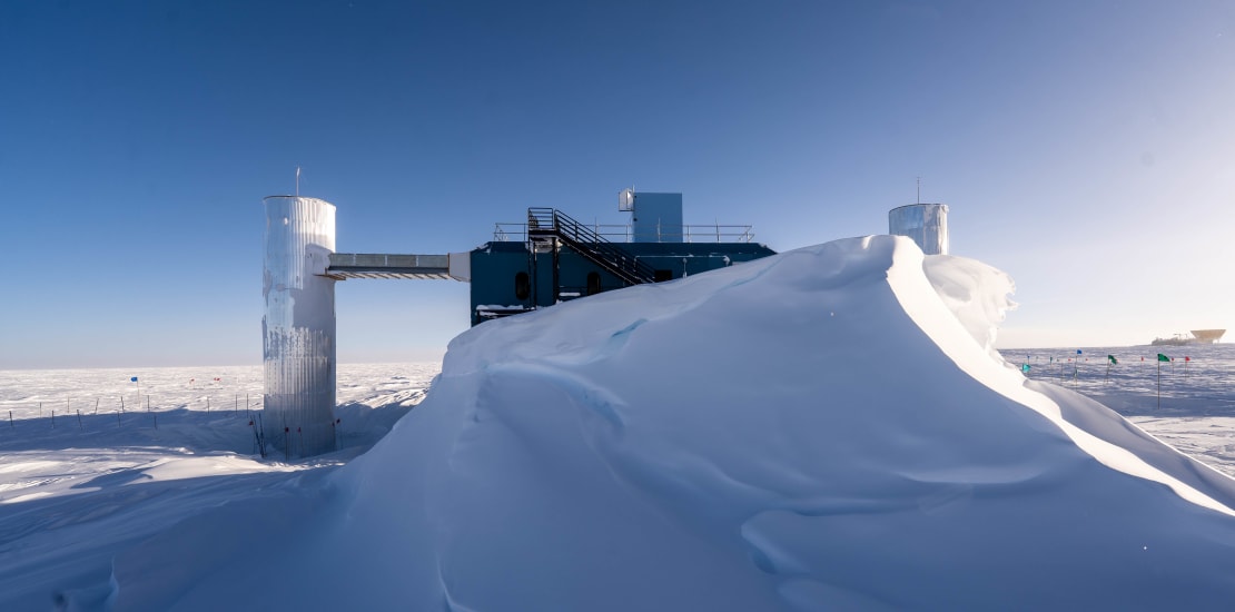 Front view of the IceCube Lab mostly blocked by large snow drift.