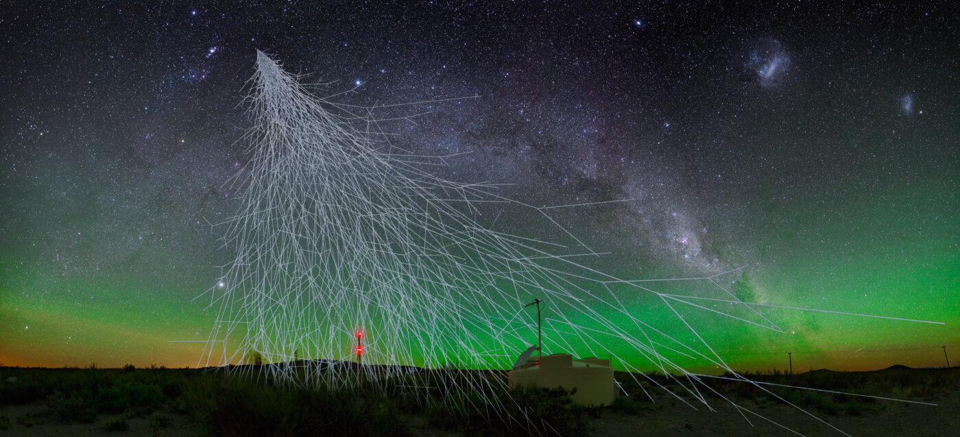 An artist's impression of cosmic rays coming down from the sky onto an observatory