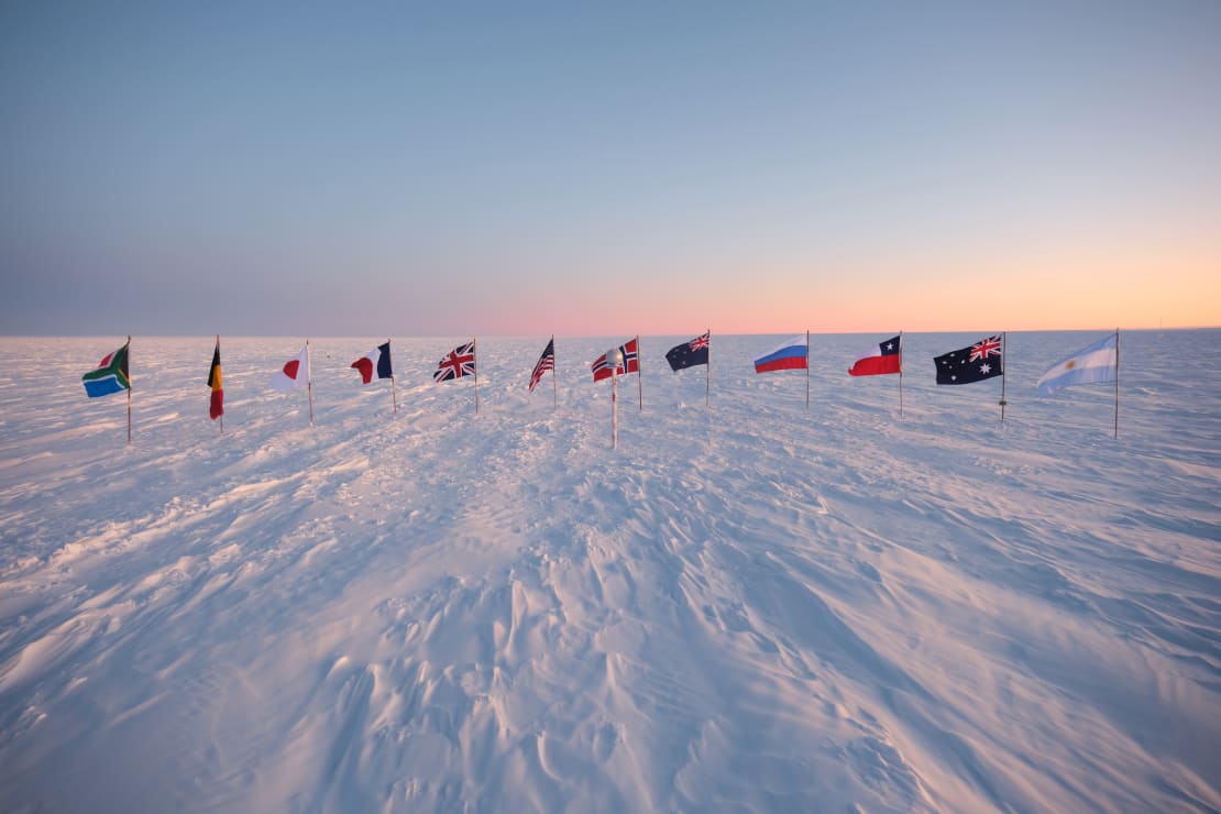 The flags at the ceremonial South Pole at sunrise, just after being replaced for the summer season.