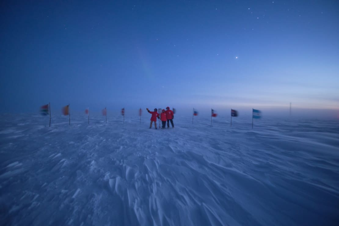 Small group photo at the ceremonial Pole at twilight.