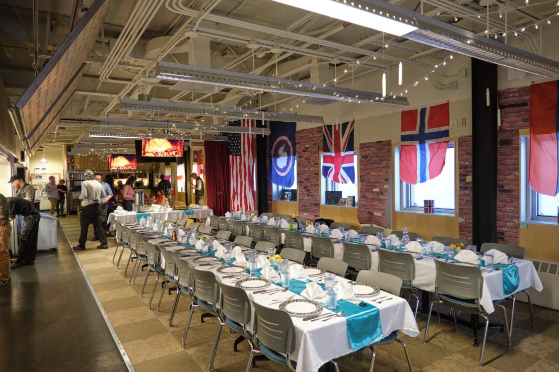 Two long tables set with formal dinnerware.