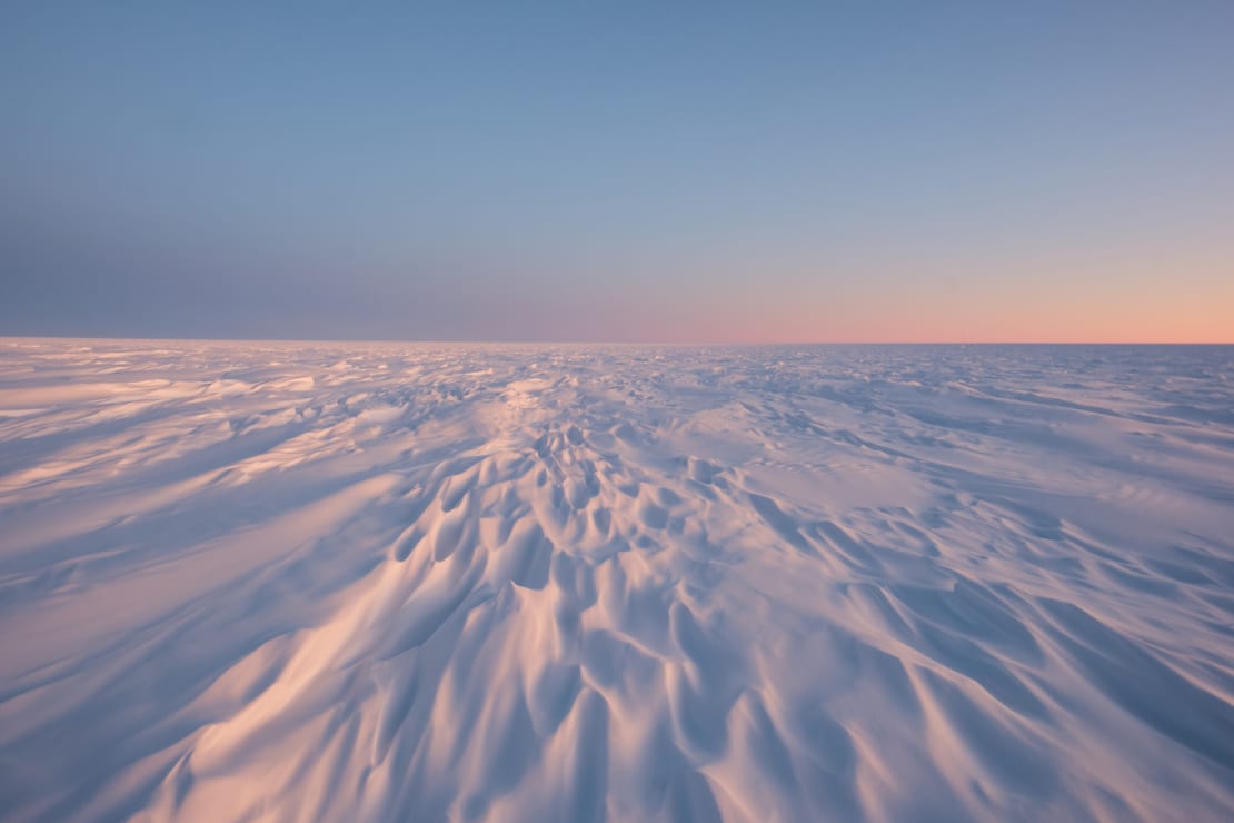 Sastrugi (snow drifts) at the South Pole at sunrise.