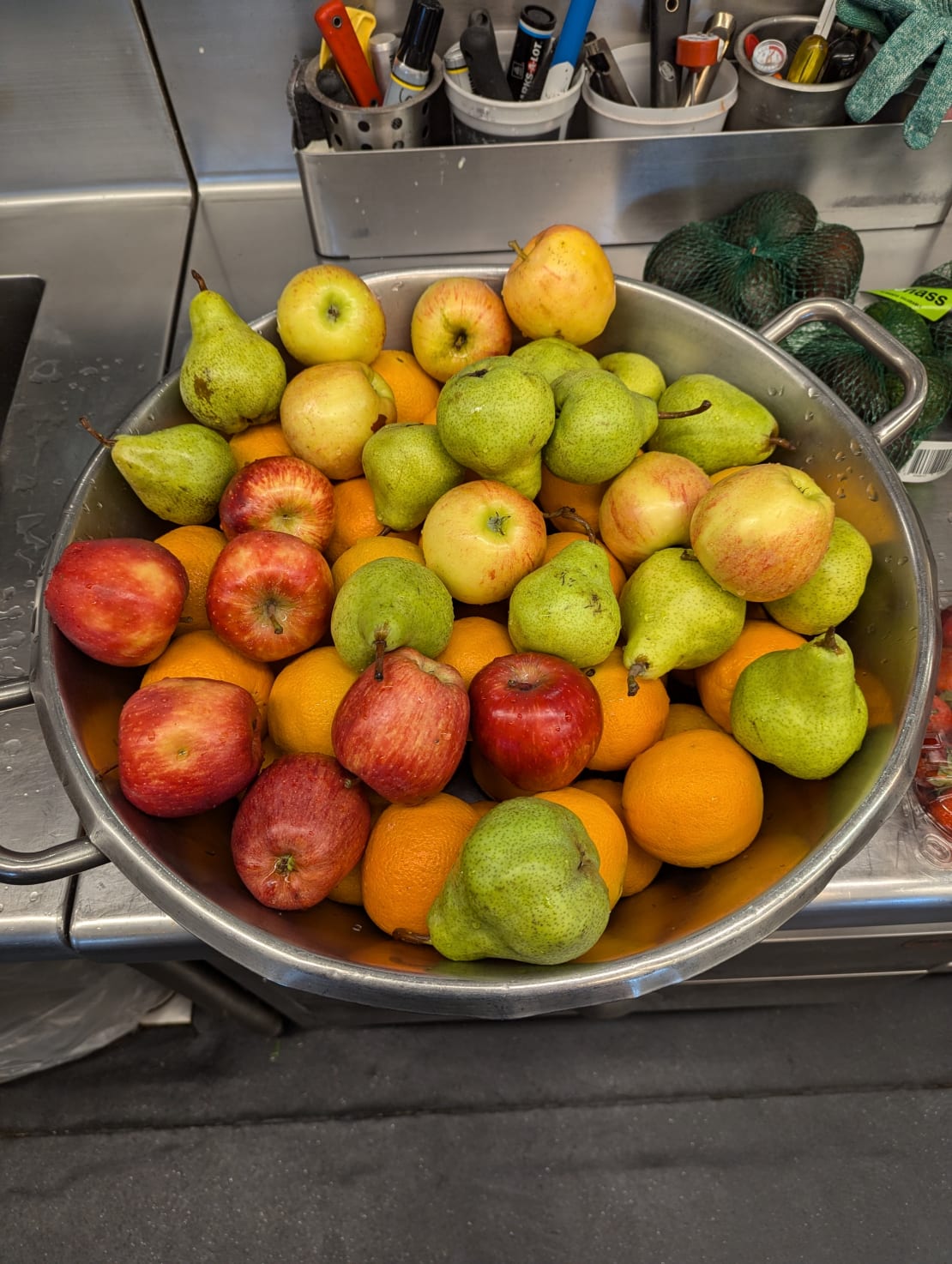 Close-up on large bowl of apples, oranges, and pears.