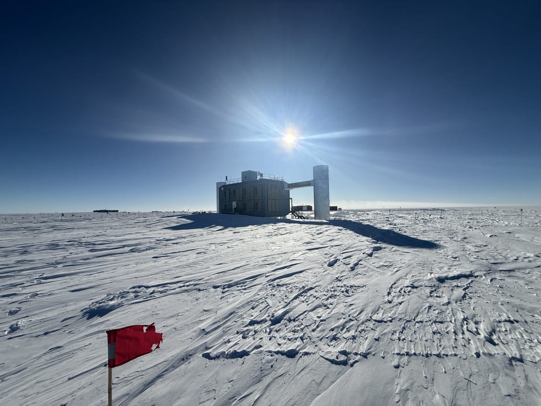 The IceCube Lab in early summer, with long shadows from low, bright sun in a blue sky