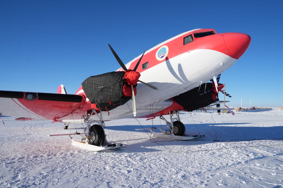 Close-up, three-quarter view of a Basler plane parked on the ice.