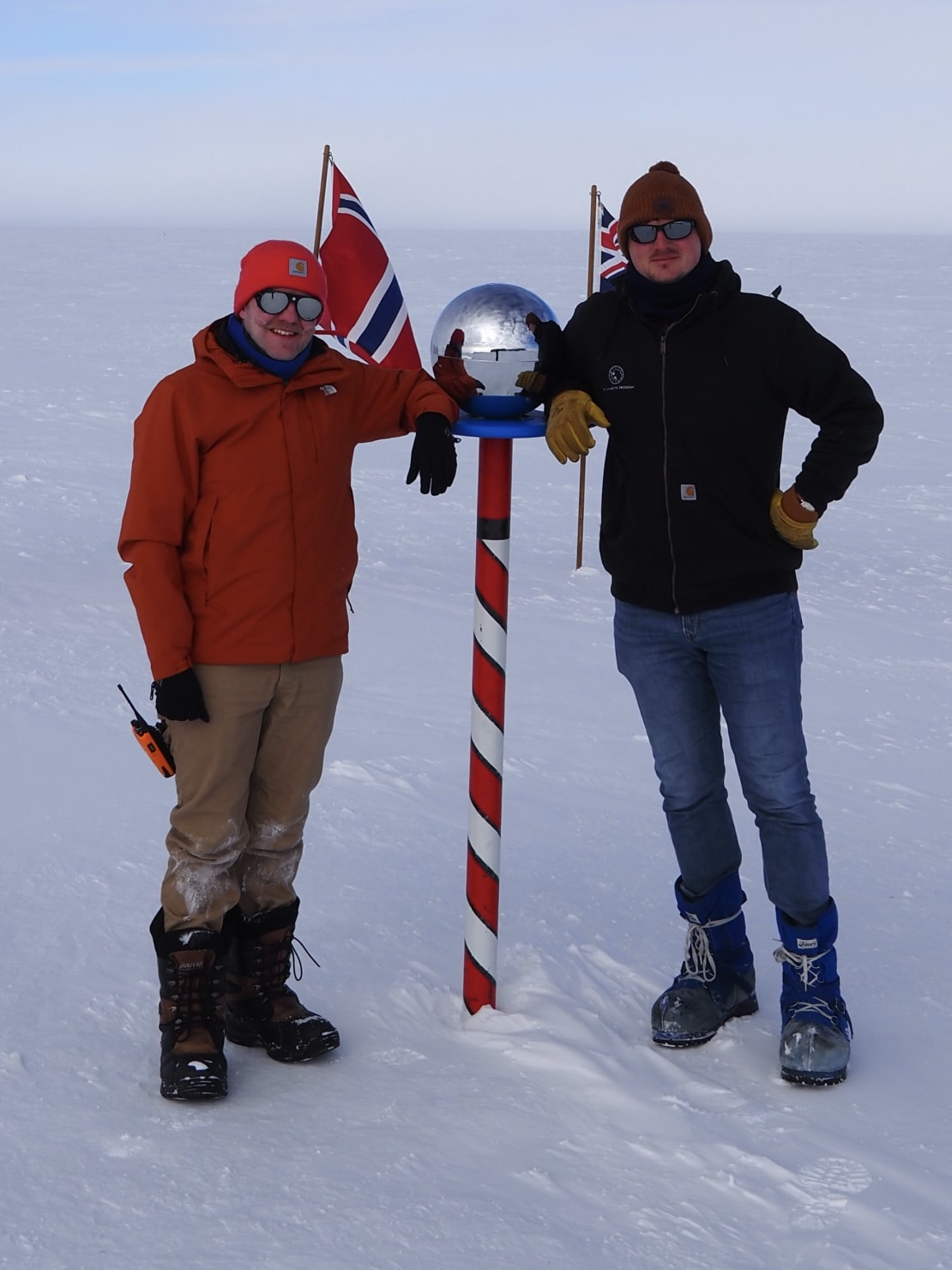 Two people flanking the ceremonial Pole.