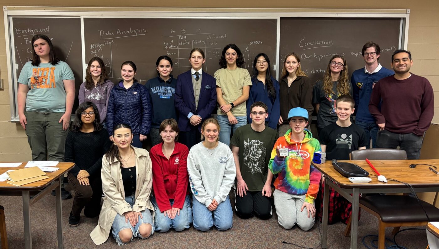 A group of people in front of a chalkboard