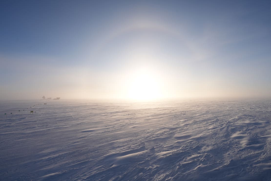 A sun halo on lowering sun at the South Pole, some mistiness along horizon.