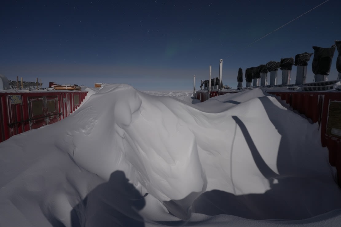 Tall snowdrifts between shipping containers.