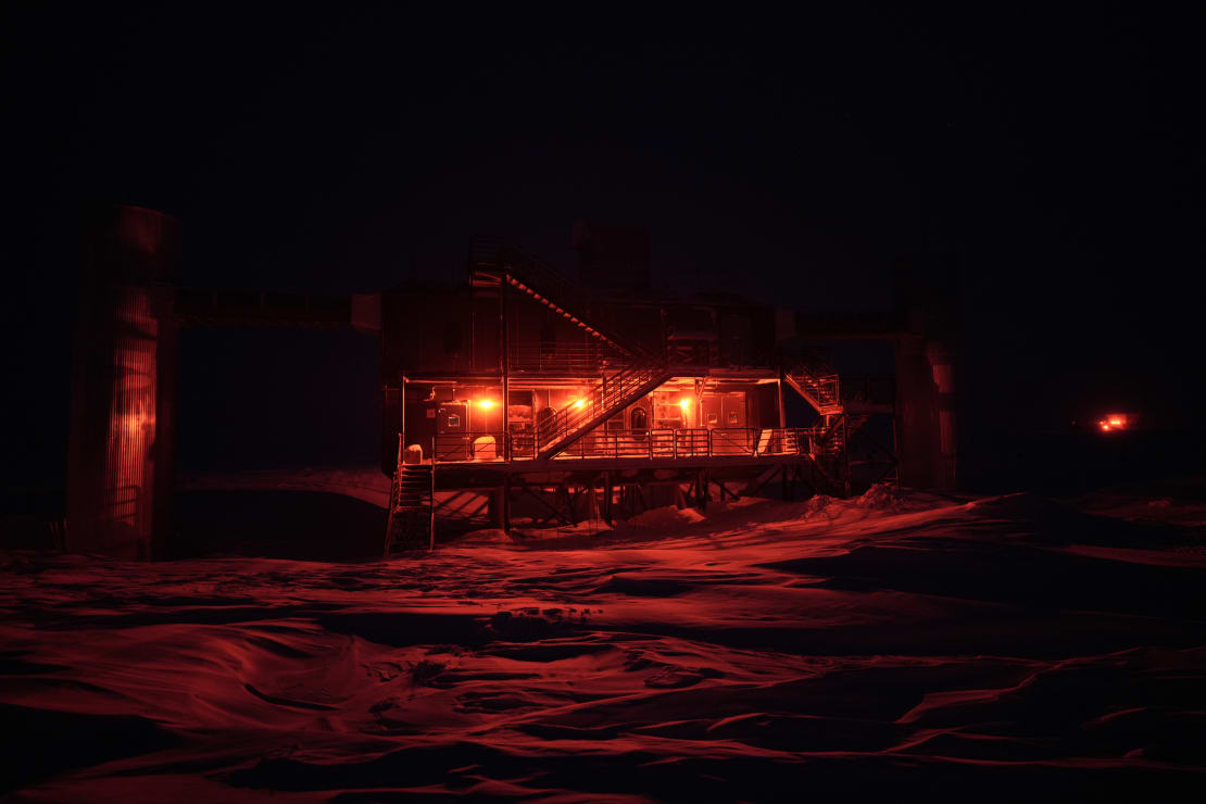 The IceCube Lab in complete darkness, lit in red lights.