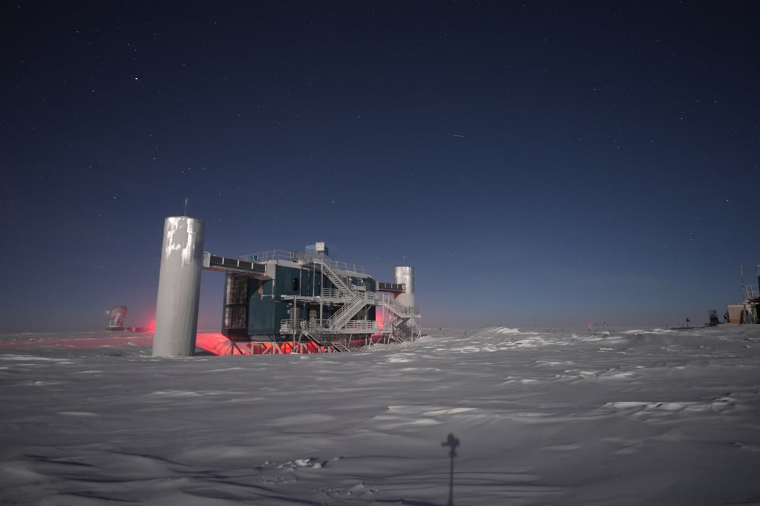 IceCube Lab under dark but clear winter sky, strongly lit by a bright moon.