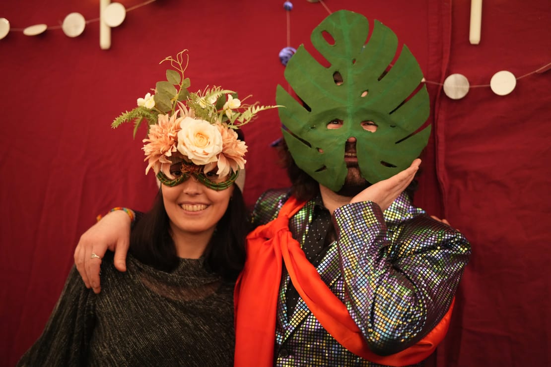 Close-up of two masked partygoers.