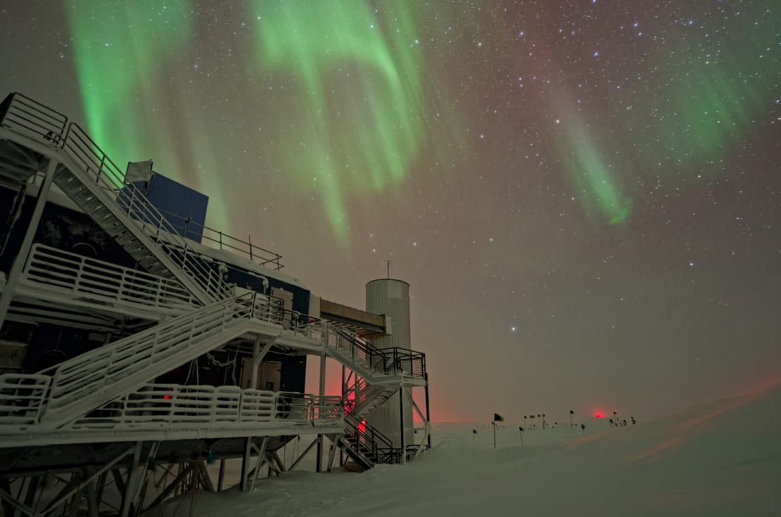 Swirling auroras over the IceCube Lab, off to the left.