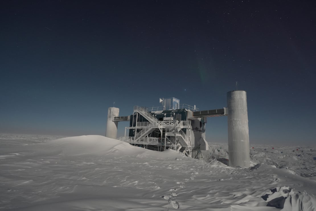 The IceCube Lab in winter under clear starry sky.