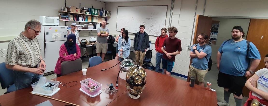 A group of people huddled around a table