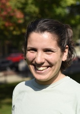 A headshot of a woman in a white shirt