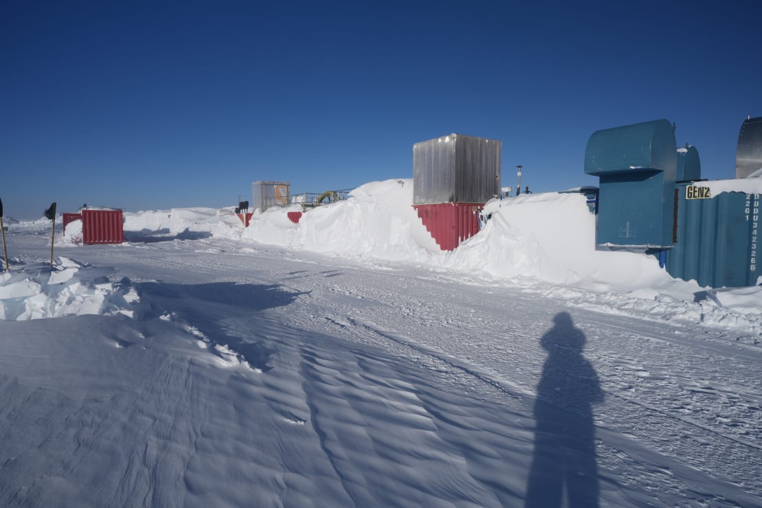 View of groomed path around drill camp with long shadow of phtographer in foreground.