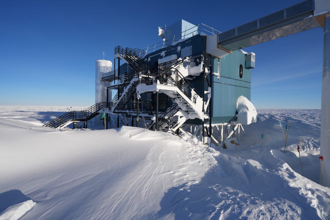 IceCube Lab, at three quarter view, on clear day, with snow drifts at base.