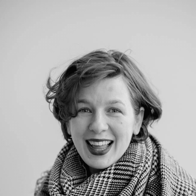 A headshot of a lady wearing a scarf in black and white