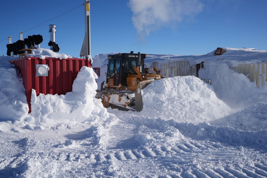 Snow plow in action around the containers at drill camp.