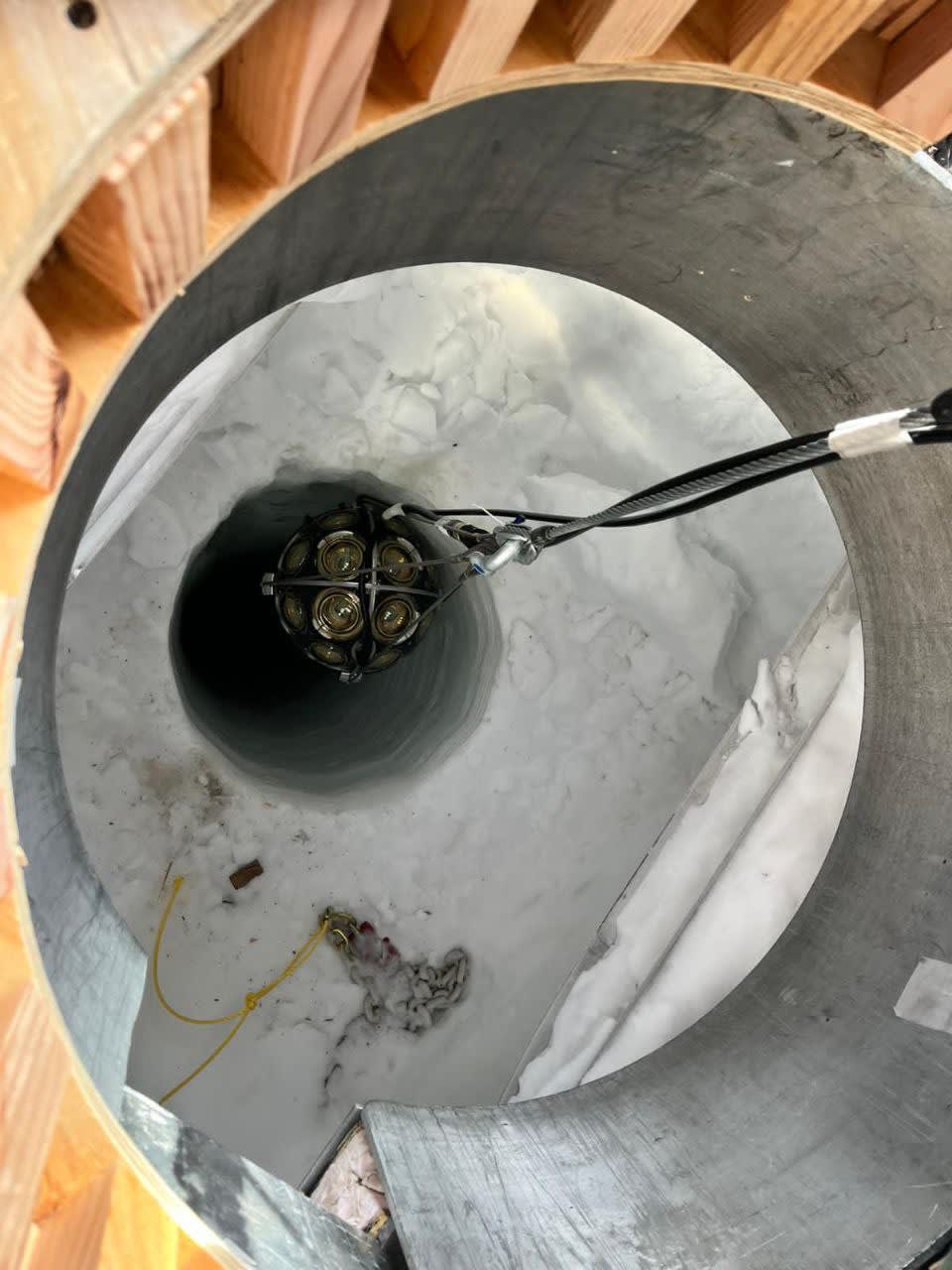A module being lowered into the hole, seen from above.