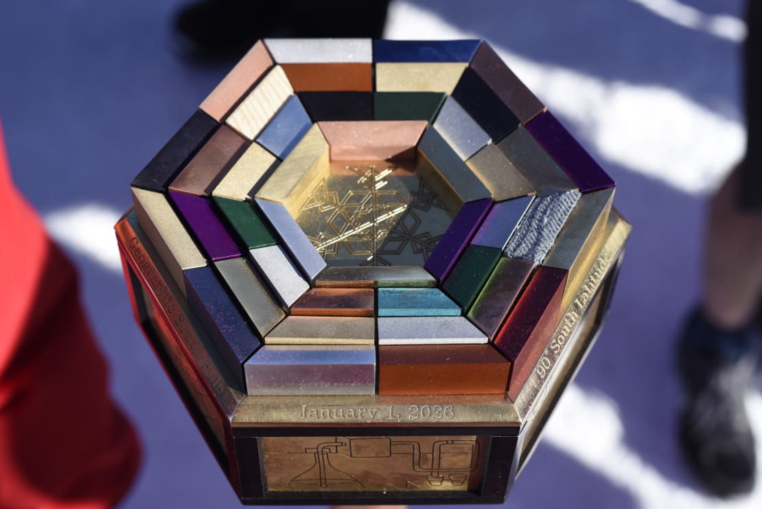 Close-up of top of a pole marker, multicolored segments in concentric hexagonal format.