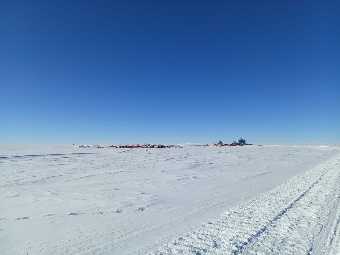 The IceCube Lab and drill camp seen from a distance on clear day.