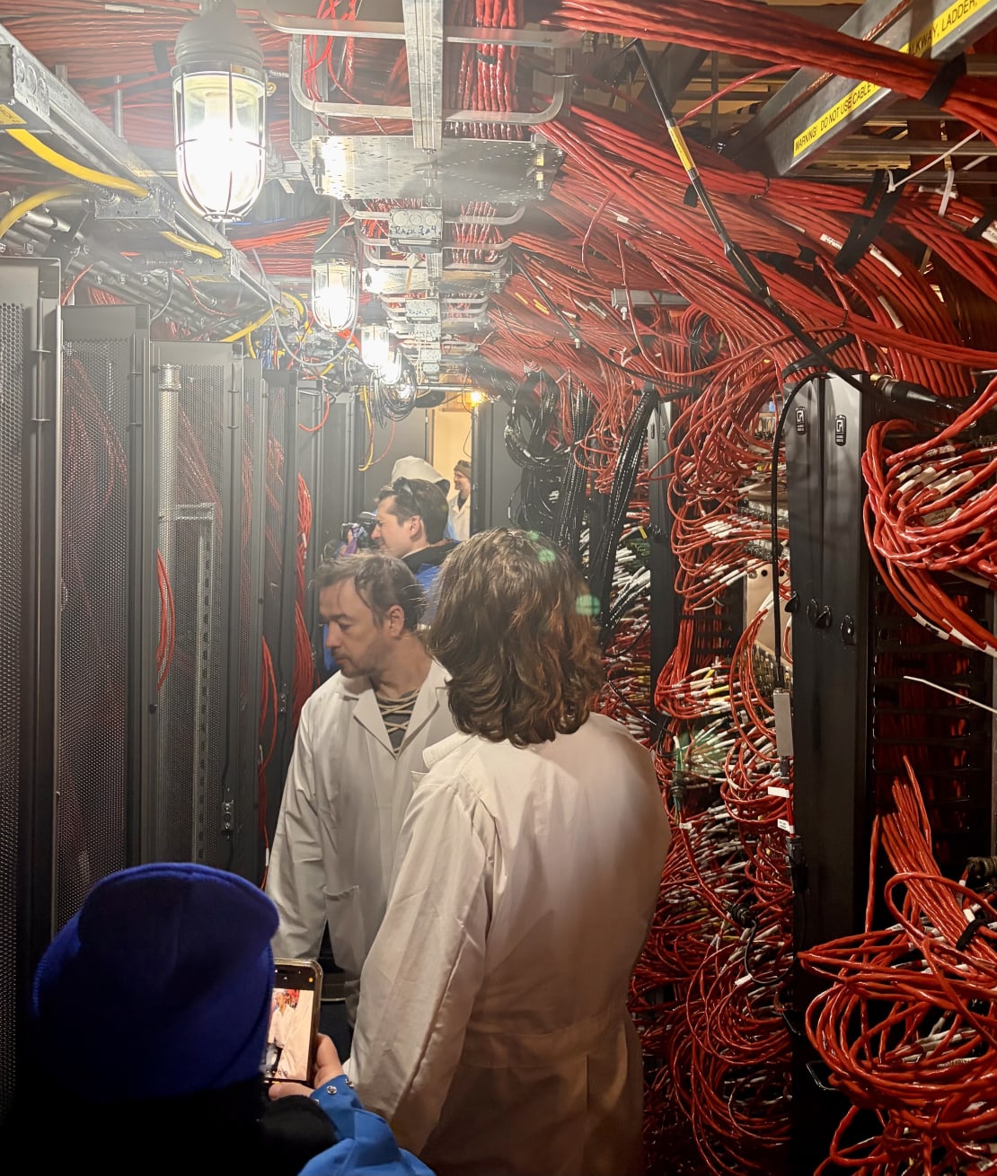 People crowding the cooridor of the IceCube Lab.