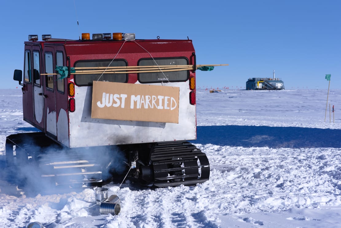 A snow vehicle with a “Just Married” sign attached to its rear.