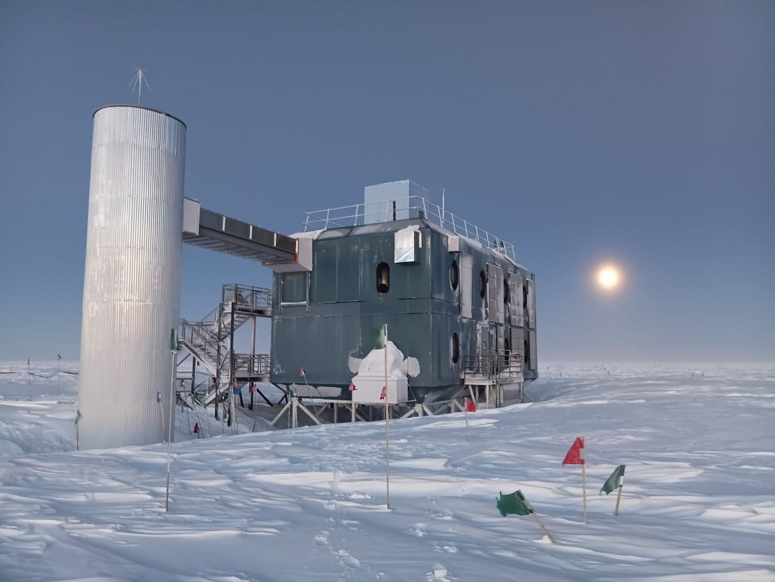 Twilight view of the IceCube Lab, with good visibility from remaining daylight and the moon low in the sky off to the right.