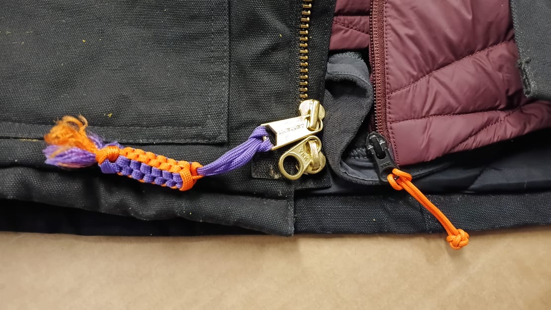 Close-up on colorful corded zipper pulls.