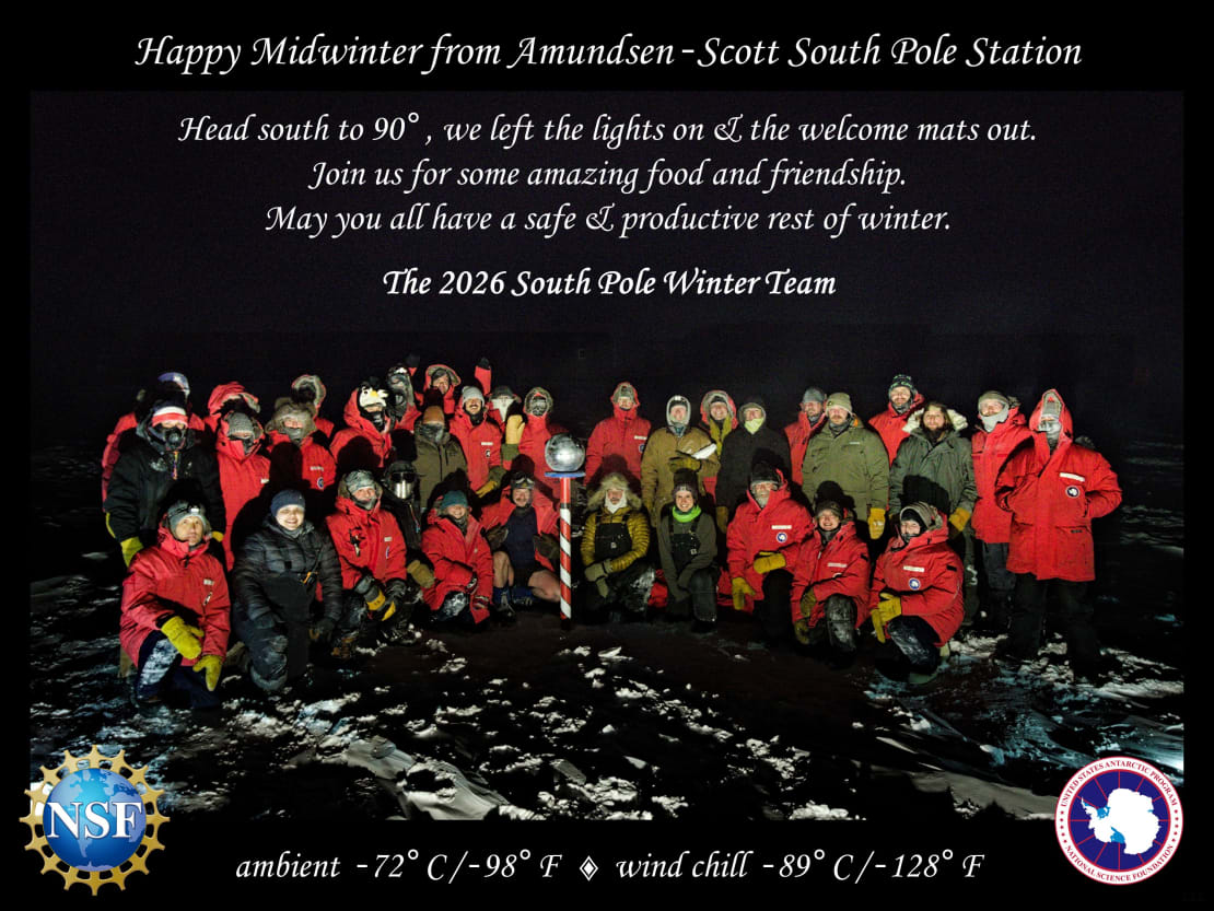 Group photo of South Pole winterovers against dark/black background, as cover of the midwinter greeting card.