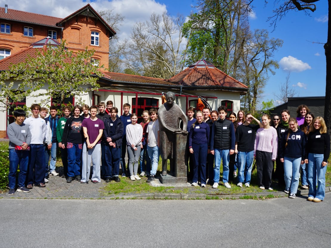 A group of people posing in front of a statue in Germany.