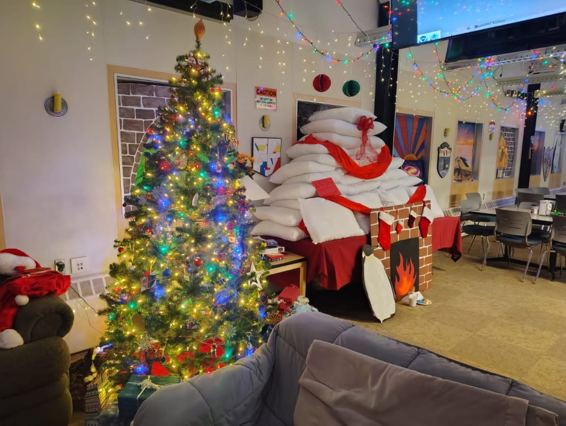Decorated Christmas tree and cardboard fireplace in the South Pole galley.