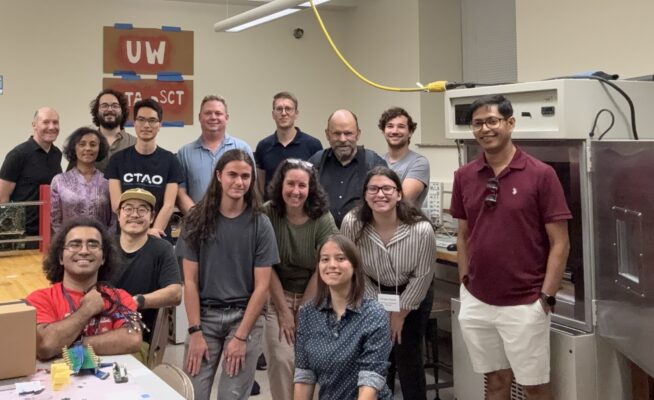 A group of people posing in a lab.