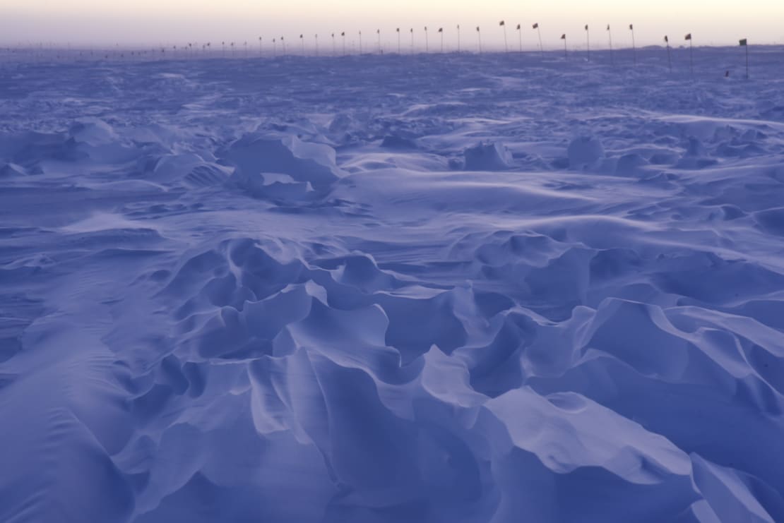 Strong shadows in the sastrugi (ice ridges) at early sunrise.